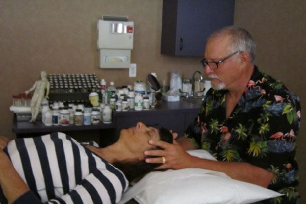 Image of a person doing cranial osteopathy manipulation